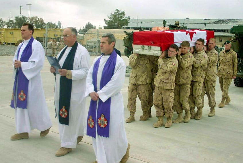 Three Canadian Forces chaplains lead the pallbearer party, as a soldier's body is sent home from Afghanistan in 2006.