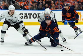 Edmonton Oilers' Ryan Nugent-Hopkins (93) battles L.A. Kings' Brendan Lemieux (48) and Matt Roy (3) during first period NHL action in Game 2 of their first round Stanley Cup playoff series in Edmonton, on Wednesday, May 4, 2022. 