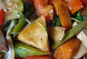 This stir-fry features mixed vegetables (onion, red pepper, celery, carrot, asparagus, zucchini, tomato, pea sprouts) with extra firm tofu.