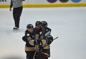 Charlottetown Islanders defenceman William Trudeau, centre, celebrates his first-period goal against the Moncton Wildcats on May 6 with teammates Patrick Guay, 16, and Jérémie Biakabutuka, 13. The Islanders defeated the Wildcats 4-2 to take a 2-0 lead in the best-of-five Quebec Major Junior Hockey League playoff series.