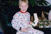  A young Blake Coleman shows off his haul of Dallas Stars-logoed mini-sticks at Christmas in 1997.