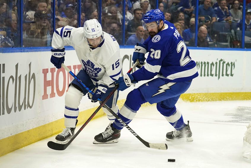 Alexander Kerfoot, here battling for the puck against Lightning’s Nick Paul, is believed, at some point, to have played in 11 of 12 possible forward slots for the Leafs this season. 