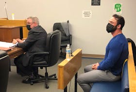 Noel Strapp (right) sits in a provincial courtroom in St. John's behind his lawyer, Ian Patey, prior to the start of his sentencing hearing Monday, May 9.