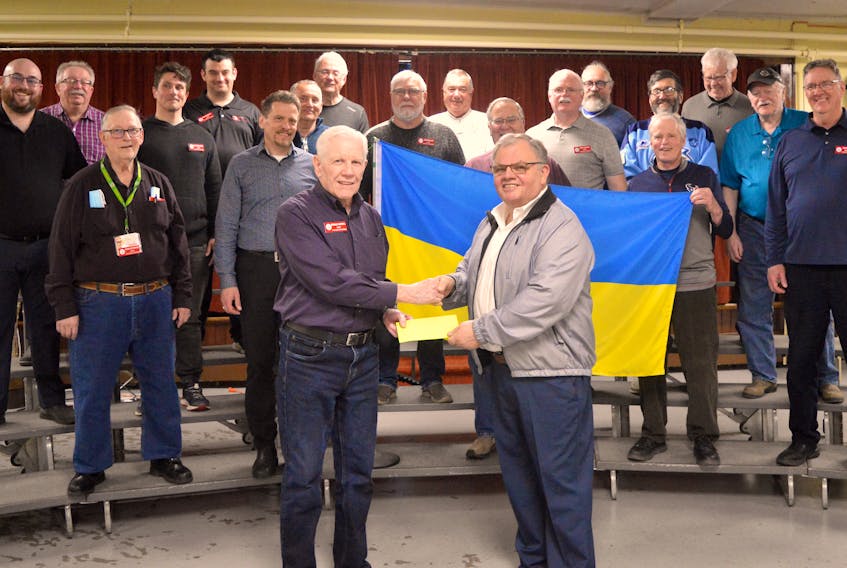 Gerald Farrell, left, president of the Cape Breton Chordsmen, presents a cheque for $1,000 to Robert Schella, chair of the St. Mary's Polish Church parish council. St. Mary’s Church in Whitney Pier has raised nearly $20,000 through a CBRM fund to help sister city Wałbrzych, Poland, provide humanitarian aid to Ukrainian refugees flee the Russian invasion. Chris Connors/Cape Breton Post