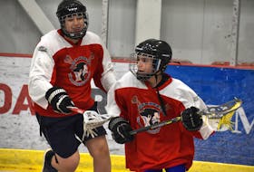 Cape Breton Warriors teammates Evan Gale, right, and Donovan Doyle participate in a drill during team practice at the Membertou Sport and Wellness Centre on Tuesday. The under-14 team will host the Truro Bearcats in their Scotia Minor Lacrosse League home opener in Membertou this weekend. The Cape Breton Lacrosse Association is rebuilding after not being able to have games for two years due to the COVID-19 pandemic. JEREMY FRASER/CAPE BRETON POST.