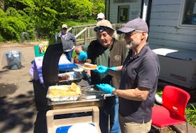 For the first time in its 41-year history, the Sydney-based Loaves and Fishes held its first barbecue Tuesday. Hot dogs, macaroni salad, and juice were on the menu for the day while those attending were also given free eggs. Among the volunteers on hand were Paul Kenrick, left, and Lloyd Tallman, who served well over 100 people. CAPE BRETON POST STAFF