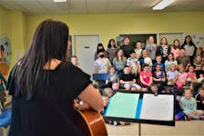 Music teacher Jane MacArthur-Summerell, front, plays Working Man by Rita MacNeil, as students at John Bernard Croak V.C. Memorial School in Glace Bay sing along on Friday. It was one of three coal mining songs students learned as part of a month-long project about Davis Day. NICOLE SULLIVAN/CAPE BRETON POST