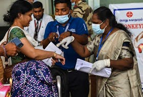 Health workers screen passengers arriving from abroad for Monkeypox symptoms at Anna International Airport terminal in Chennai, India, on June 3, 2022.  