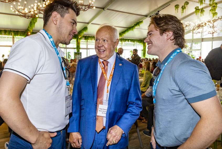 Hall of Fame Montreal Canadien Yvan Cournoyer chats with current Habs Nick Suzuki, left, and Cole Caufield at the 18th annual Sports Celebrity Breakfast, raising funds for the Cummings Jewish Centre for Seniors in Montreal on Sunday, June 12, 2022.