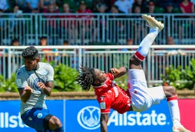 Cavalry FC striker Aribim Pepple attempts a bicycle kick over HFX Wanderers defender Eriks Santos late in their Canadian Premier League match Saturday in Calgary. - CANADIAN PREMIER LEAGUE