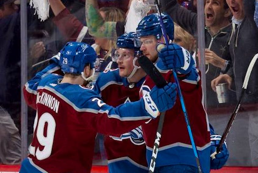Cale Makar #8 of the Colorado Avalanche celebrates with Valeri Nichushkin #13 and Nathan MacKinnon #29 after scoring a goal against the Edmonton Oilers during the first period in Game One of the Western Conference Final of the 2022 Stanley Cup Playoffs at Ball Arena on May 31, 2022 in Denver, Colorado.