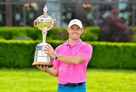 Rory McIlroy of Northern Ireland poses with the trophy after winning the RBC Canadian Open at St. George's Golf and Country Club on Sunday in Toronto.