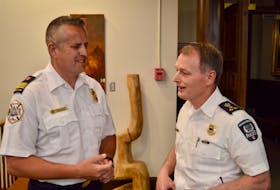 Tim Mayme, left, deputy chief of the Charlottetown Fire Department, and Charlottetown Police Services Chief Brad MacConnell talk outside council chambers at city hall on June 13 following the regular public meeting of council.