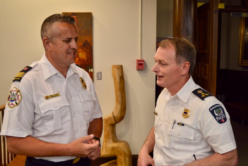 Tim Mayme, left, deputy chief of the Charlottetown Fire Department, and Charlottetown Police Services Chief Brad MacConnell talk outside council chambers at city hall on June 13 following the regular public meeting of council.