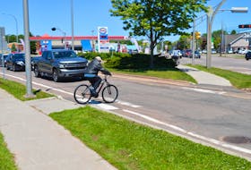 Traffic stops on June 15 to allow a cyclist to cross a portion of Brackley Point Road in Charlottetown that will be turned into a roundabout this year. Dave Stewart • The Guardian
