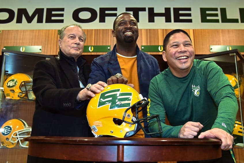 Unveiling the return to the double-E helmet design are, from left, Dan McKinnon, former assistant coach, Mookie Mitchell, former receiver and current EE Football Alumni Association president, as well as Elks president and CEO Victor Cui at Commonwealth Stadium in Edmonton on March 3, 2022.