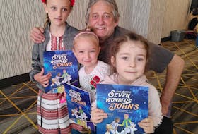 Author Herbert F. Hopkins reads to some Unkranian children who attended a recent reading of  "Jesse and the Seven Wonders of St. John’s".