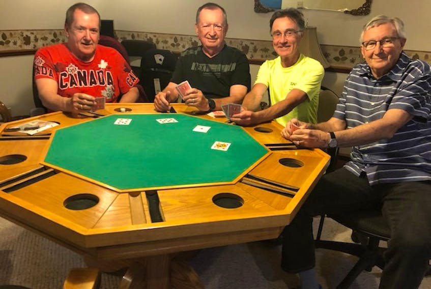 Ernie MacDonald, Glenn Morton, Merton Arbuckle and Robert MacDonald still gather once a month with a couple of others to play poker, their tradition dating back 40 years. 