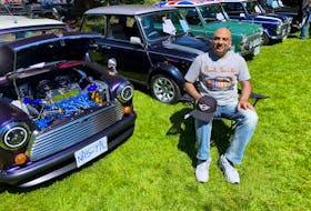 Nadir Ibadullah poses with his collection of classic Mini cars on display at Vancouver’s All-British Field Meet. Alyn Edwards photo