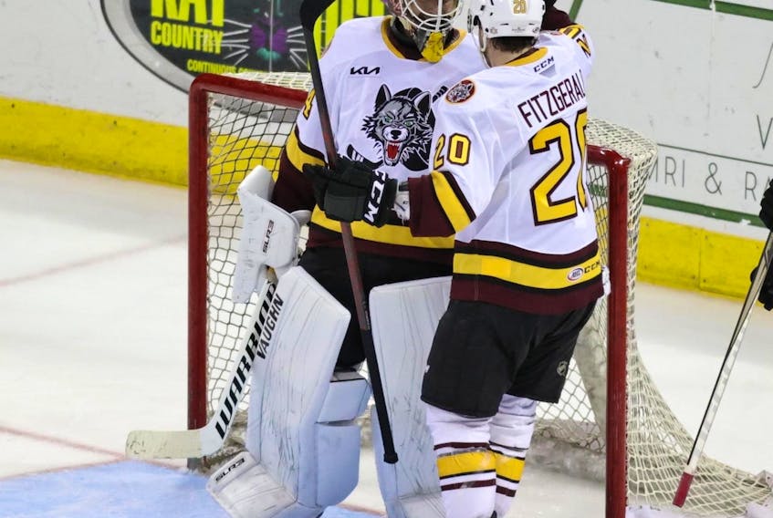 Lingan’s Cavan Fitzgerald, right, celebrates a playoff victory with goaltender Alex Lyon during American Hockey League Calder Cup playoff action against the Stockton Heat on June 8. Fitzgerald and the Chicago Wolves will play for the Calder Cup, beginning on Sunday in Chicago. PHOTO CONTRIBUTED/CHICAGO WOLVES.