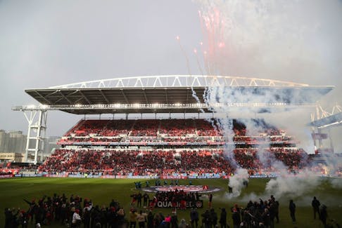 Canadian soccer fans cheer the national team's win over Jamaica at BMO Field in Toronto on March 27, 2022.
