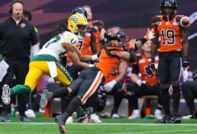 B.C. Lions defensive back Marcus Sayles, right, dives to knock down a pass intended for Edmonton Elks wide-out Derel Walker in Vancouver on Saturday, June 11, 2022.