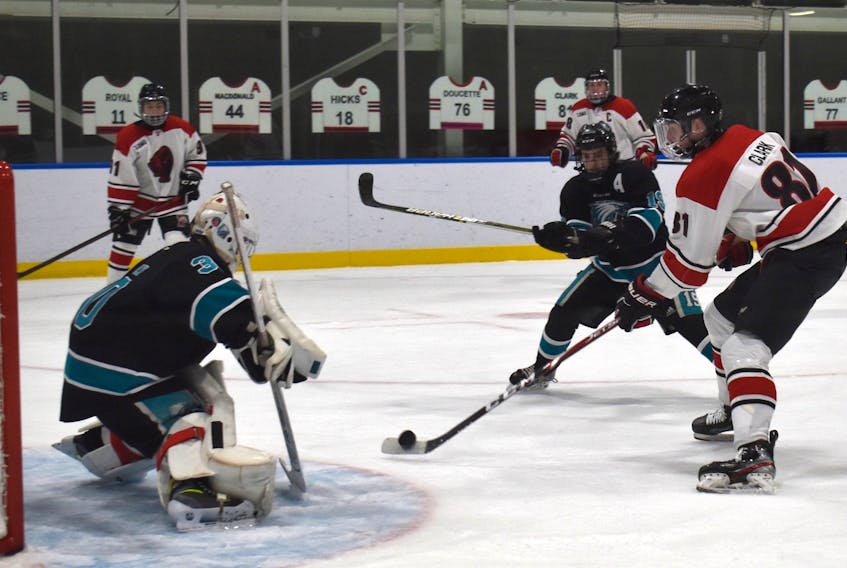 Landon Clark of the Glace Bay Panthers, right, fires a backhand on goal during action at the Panther Classic high school hockey tournament at the Miners Forum in Glace Bay in December. Clark was named the Cape Breton High School Hockey League’s regular season and playoff most valuable player. JEREMY FRASER/CAPE BRETON POST.