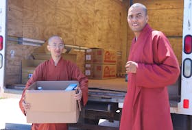 Venerables Dan, left, and Eli, monks with the Great Enlightenment Buddhist Institute Society, led planning for the End Hunger in P.E.I. drive, which gave out 250 food boxes over the weekend. - Logan MacLean • The Guardian