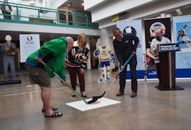 Pictou West MLA Karla MacFarlane drops the puck for the opening of a hockey-themed exhibit at the Museum of Industry in Stellarton.