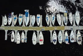 Sailboats sit tied up at the Holyrood marina Thursday afternoon. Work continued on shore as boat owners took their vessels out of onshore winter storage and had them lifted into the water for some summer fun.