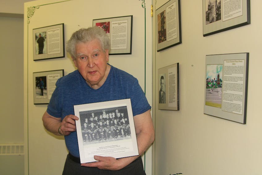 Albert Johnson holds the photo of the Middleton and District Mustangs hockey team that is on display at the Middleton Sports Heritage Wall of Fame. The Mustangs, who Johnson coached, won the Nova Scotia atom C championship in 1984-85.