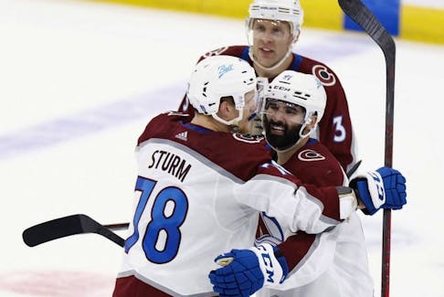 Avalanche forward Nazem Kadri, right, celebrates with Nico Sturm, left, and Jack Johnson after scoring a goal in overtime to defeat the Lightning 3-2 in Game 4 of the NHL Stanley Cup Final at Amalie Arena in Tampa, Fla., Wednesday, June 22, 2022.
