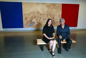 Curator Wanda Nanibush, left, and artist Robert Houle pose with the 1992 acrylic and conte crayon on canvas, Kanata, which is part of the Robert Houle: Red is Beautiful exhibit at Contemporary Calgary on Wednesday, June 22, 2022. Nanibush is also the curator of Indigenous Art at the Art Gallery of Ontario.