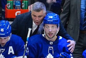 Toronto Maple Leafs head coach Sheldon Keefe congratulates forward Michael Bunting on assisting on the goal by forward Auston Matthews against the Tampa Bay Lightning during the third period of game five of the first round of the 2022 Stanley Cup Playoffs at Scotiabank Arena. 
