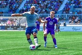 HFX Wanderers' Peter Schaale plays the ball away from a Pacific FC defender during Canadian Premier League action on Saturday in Langford, B.C. - Sheldon Mack/Canadian Premier League