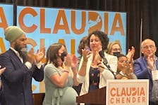 New Nova Scotia NDP leader Claudia Chender (centre) claps on stage with federal leader Jagmeet Singh (left) and former provincial leader Gary Burrill after she was officially elected as leader Saturday, June 25, 2022.
