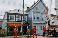 Nova Scotia Power work crews were on the scene of a collision between a skidding car and a power pole on Saturday morning. - Shawn Duggan