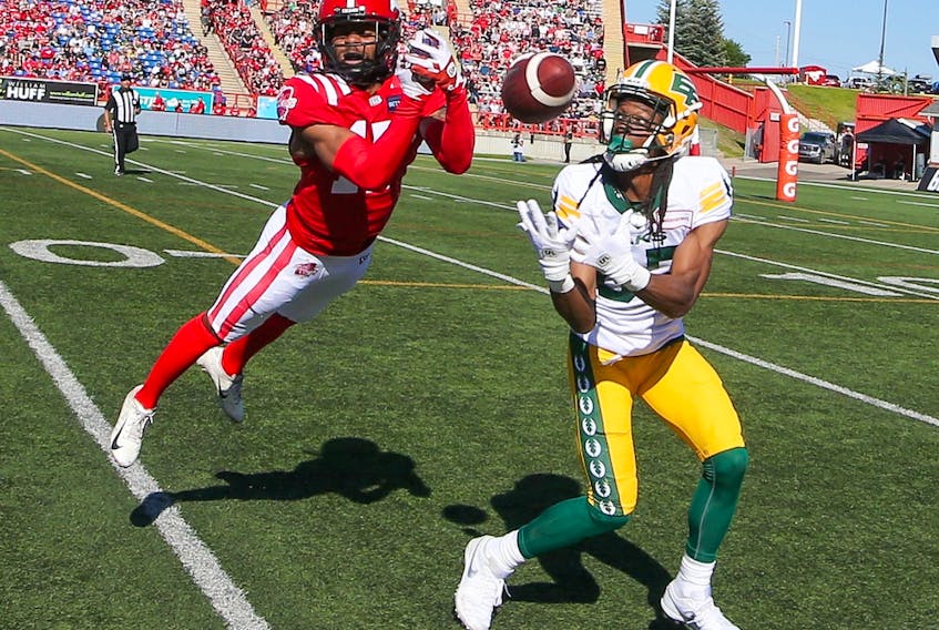 Calgary Stampeders defensive back Dionté Ruffin and Edmonton Elks' receiver Derel Walker clash during CFL action at McMahon Stadium in Calgary on Saturday, June 25, 2022. 