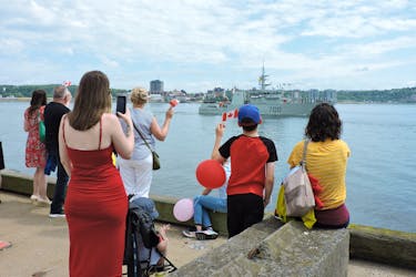 Families wave to HMCS Kingston as it sails past the jetty at Her Majesty’s Canadian Dockyard Halifax on Sunday to join NATO’s Operation Reassurance in the North Atlantic and Baltic Sea.