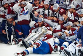 The Colorado Avalanche players react as Nicolas Aube-Kubel (16) falls and drops the Stanley Cup during post-game photos after defeating the Tampa Bay Lightning in Game 6 Sunday night in Florida. (USA TODAY Sports)