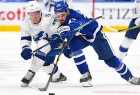 Tampa Bay Lightning forward Ondrej Palat pursues the puck with Toronto Maple Leafs defenseman Timothy Liljegren in the second period at Scotiabank Arena. 