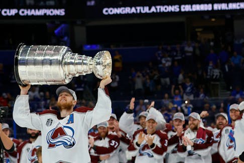 Colorado Avalanche centre Nathan MacKinnon (29) celebrates with the Stanley Cup after the Avalanche game against the Tampa Bay Lightning in game six of the 2022 Stanley Cup Final at Amalie Arena in Tampa Bay, Fla., Sunday, June 26, 2022. - Geoff Burke / USA TODAY Sports