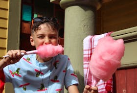 Carter Winchester, 11, enjoys some cotton candy at Summerside’s Olde Fashioned Carnival.
