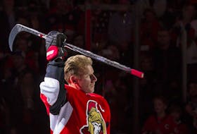 File photo/ Daniel Alfredsson salutes the crowd after skating with the Ottawa Senators one last time in Ottawa on Thursday December 4, 2014. 