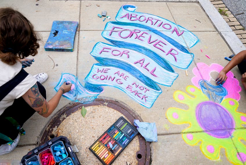 Abortion-rights activists draw on the sidewalk in Washington on June 24 following U.S. Supreme Court’s decision to overturn Roe v. Wade ending constitutional protection for abortion.