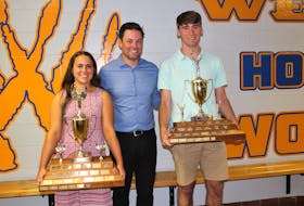 Westisle Composite High School athletic director Brett Corcoran, centre, congratulates the 2021-22 athletes of the year, Macy Hackett, left, and Nathan Smith. Westisle recently handed out its athletic awards for the 2021-22 school year. Contributed