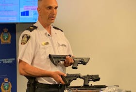 Winnipeg Police Insp. Max Waddell shows off a prohibited AR-15 rifle lower end receiver manufactured from a 3-D printer (lower) and an authentic AR-15 lower end receiver at a press conference at Winnipeg Police headquarters on Tuesday, June 9. 2020. Winnipeg Police announced a large seizure of firearms in two separate investigations including the AR-15 lower end receiver and a Glock 19 handgun lower receiver which had been manufactured out of plastic using a 3-D printer. The manufactured firearms are referred to as 'ghost guns' as they have no serial number.