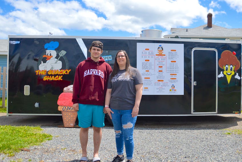 Chrissy Grace, right, and her son Coady Grace stand in front of the family’s food truck, the Quacky Shack. Now in its second year of operation, they changed their menu to include fried chicken after customers kept mistaking the cartoon duck on the side for a chicken. The truck sets up 761 Mahon St. in New Waterford, not far from the local Sobeys store, most days from 2-7 p.m., depending on the weather. Chris Connors/Cape Breton Post