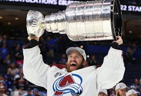 Darcy Kuemper of the Colorado Avalanche lifts the Stanley Cup after defeating the Tampa Bay Lightning 2-1 in Game Six of the 2022 NHL Stanley Cup Final at Amalie Arena on June 26, 2022 in Tampa, Florida.