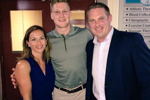 Nathan MacKinnon, centre, poses for a photo with Jon and Lisa Greenwood in 2017. - Contributed